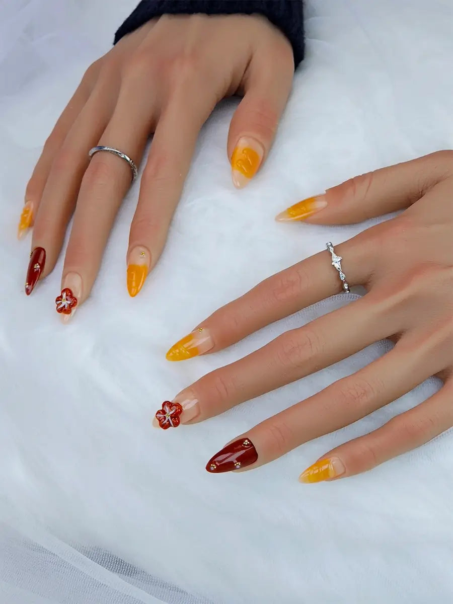 Handcrafted Almond Press Ons with Red-Orange Floral Art and Golden Pearl Details